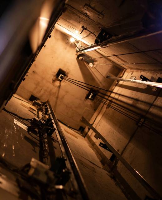 Man,Repairing,An,Elevator,At,Night,Inside,A,Shaft,Of Man,Repairing,An,Elevator,At,Night,Inside,A,Shaft,Of